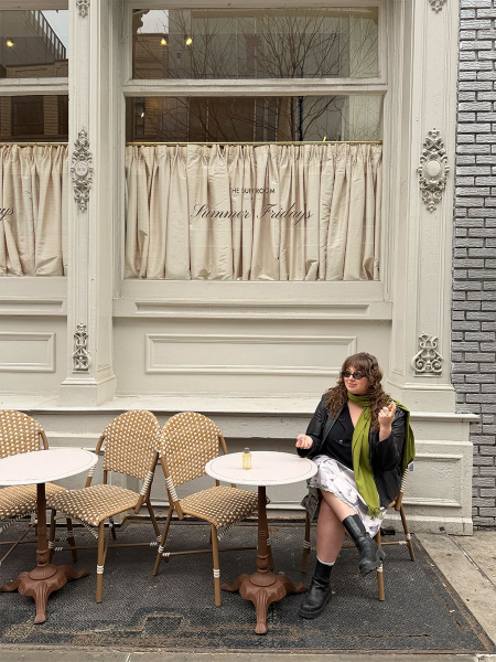 Image may contain Person Sitting Furniture Table Chair Indoors Restaurant Dining Table Clothing Coat and Cafeteria